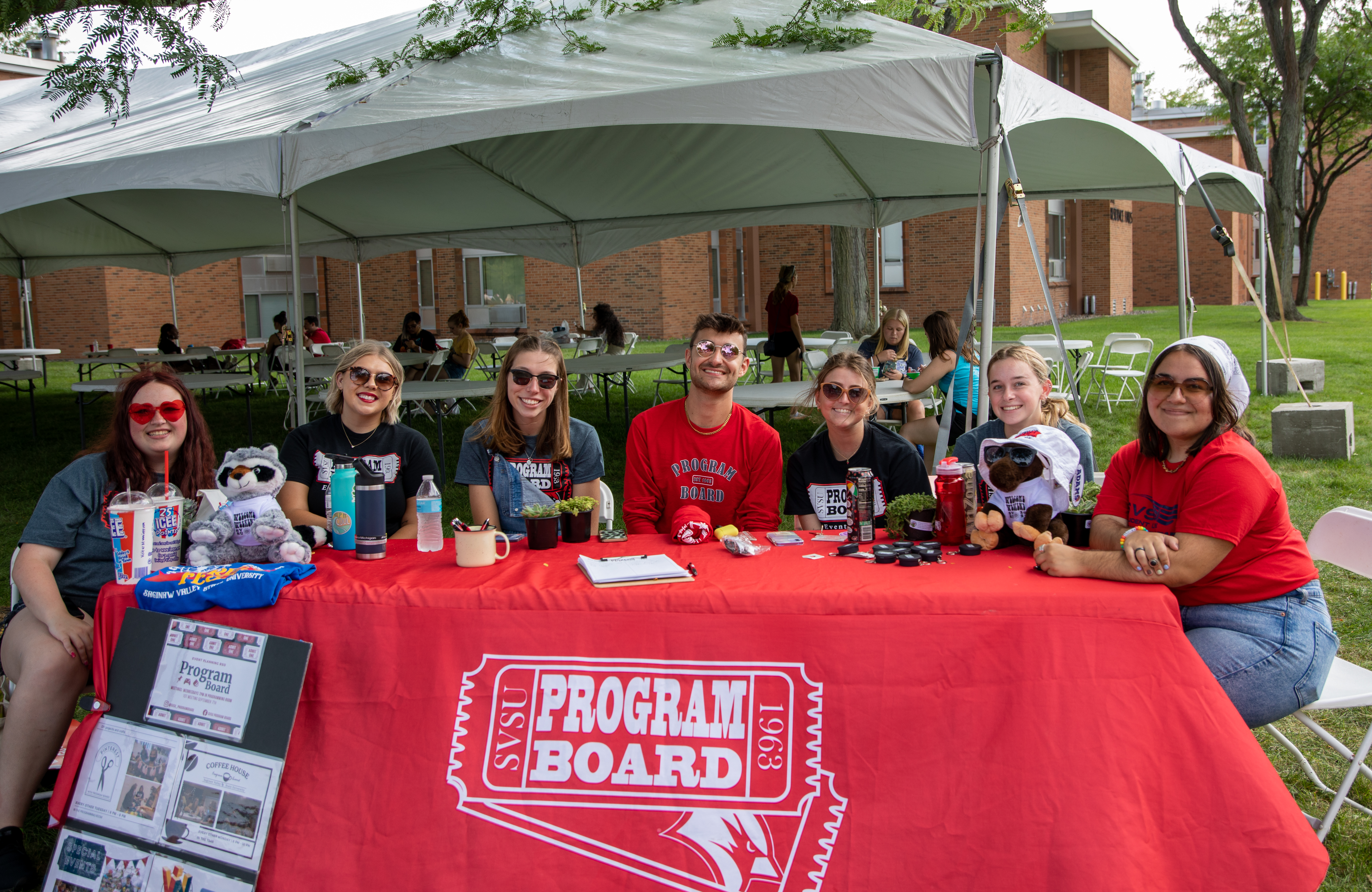 Students seated at a table sharing information about Program Board to fellow students.